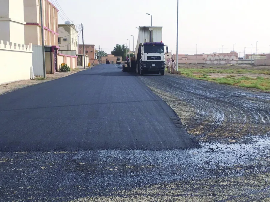 New asphalt layer being laid on a residential street