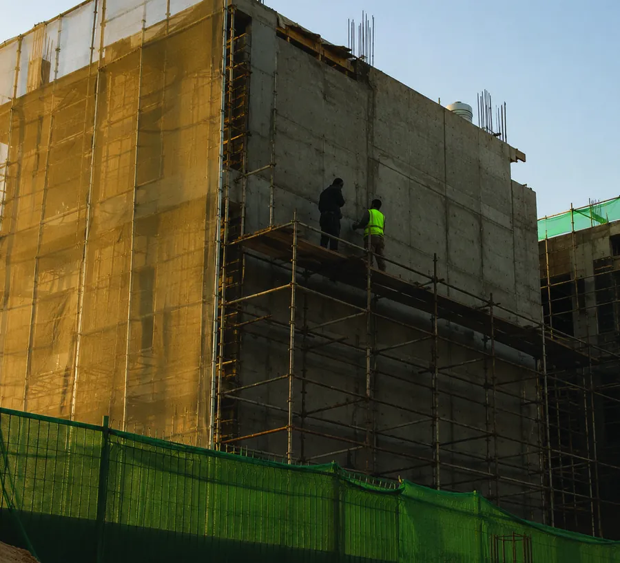 Multi-storey structure under construction behind scaffolding