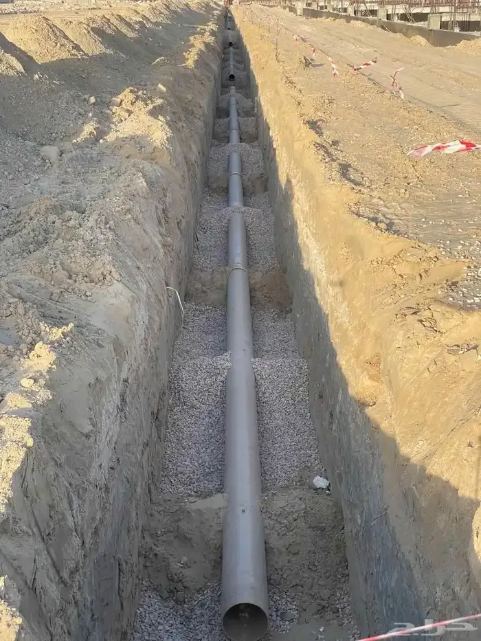 Drainage main bedded in a prepared trench
